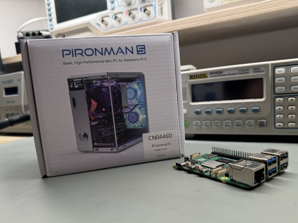 A photo showing the Pironman 5 box sitting on a lab desk, with the Raspberry Pi 5 next to it.