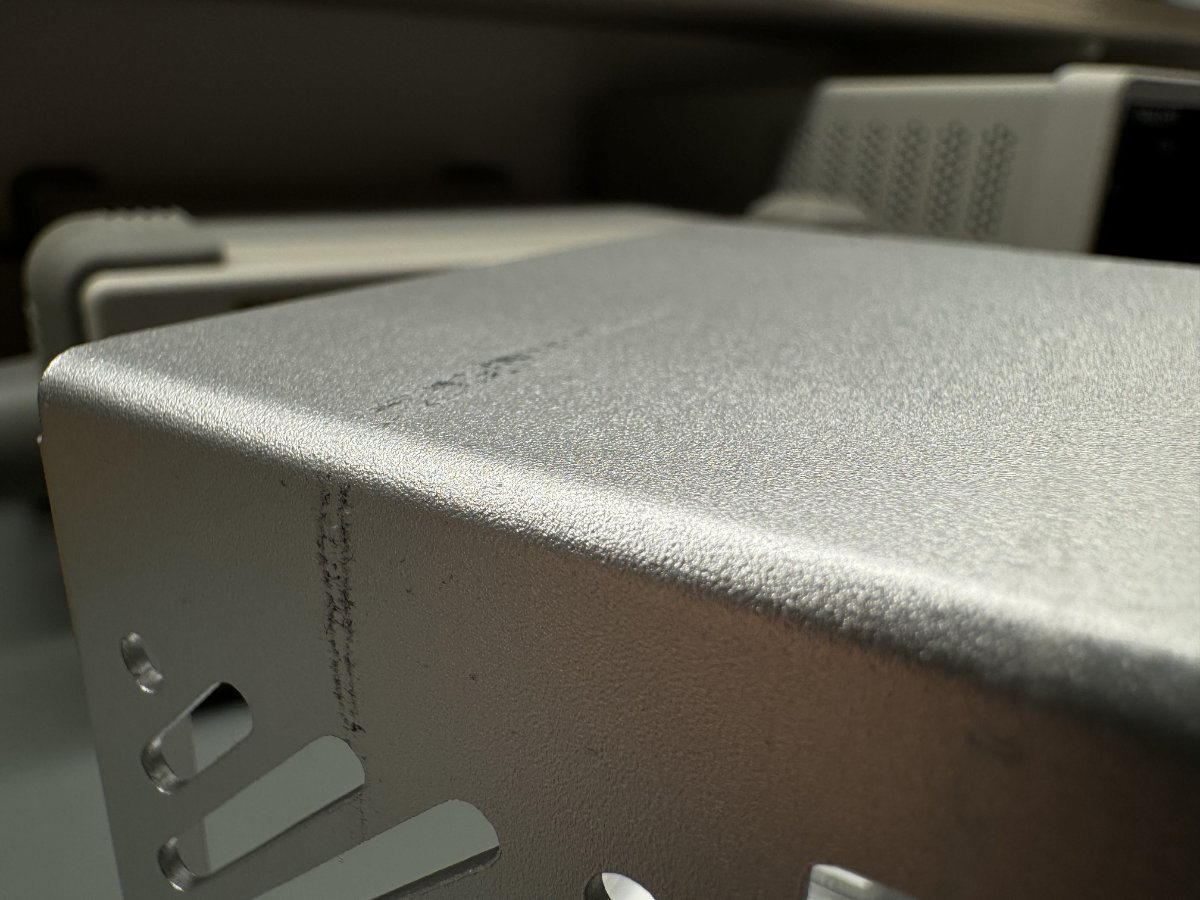 A close-up photo showing black manufacturing residue left on one of the Pironman 5’s aluminum plates.