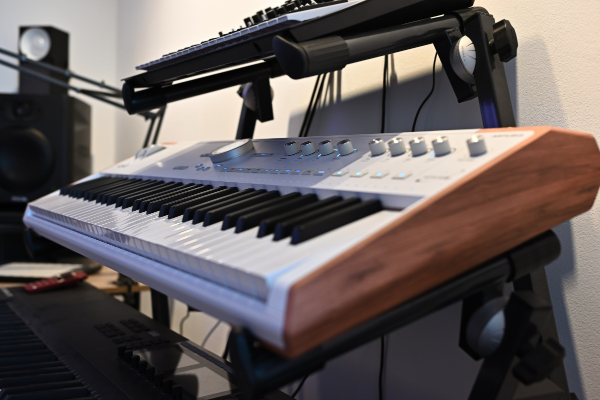 A wider-angle photo showing the AstroLab on a triple studio keyboard stand, above a Komplete Kontrol S88 MK2 and below a Korg Minilogue xd.