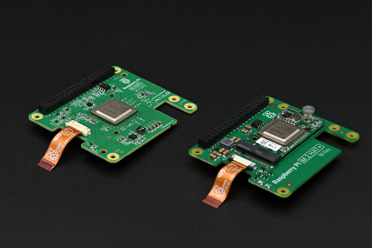 A photo showing a side-by-side comparison of the Raspberry Pi AI HAT+ and the Raspberry Pi AI Kit, showing how similar these two are.