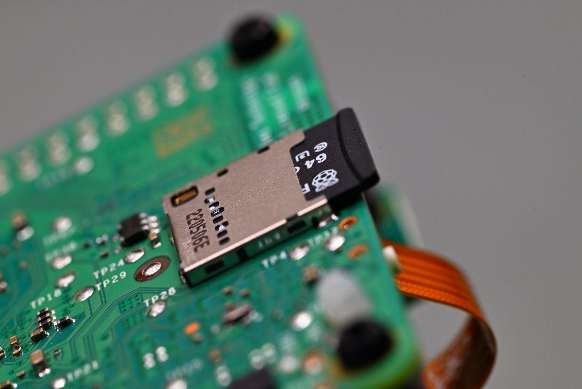 A Raspberry Pi SD card inserted into the Raspberry Pi 5 computer.