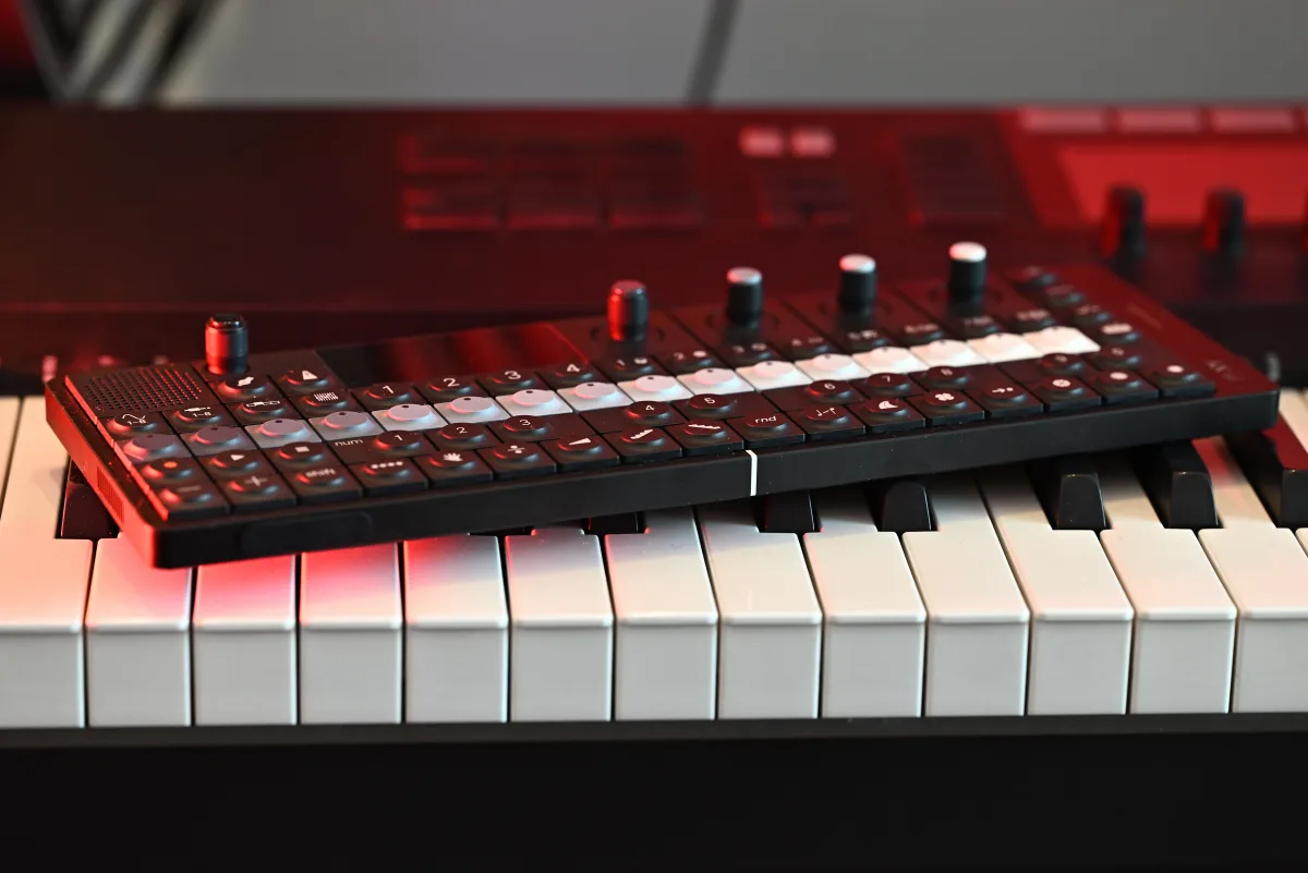A photo of the OP-XY sitting on top of a Komplete Kontrol S88 MIDI controller.
