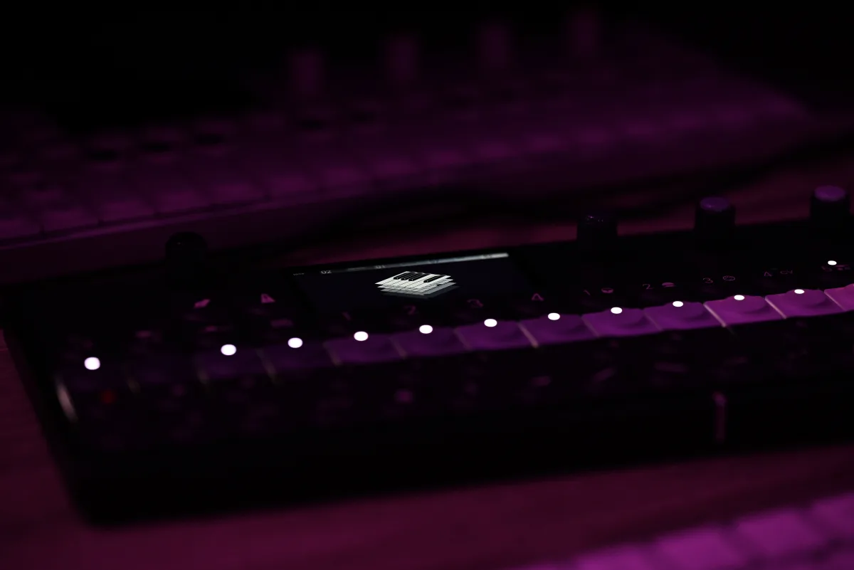 A photo of the OP-XY used in the dark, demonstrating its low-light usability.