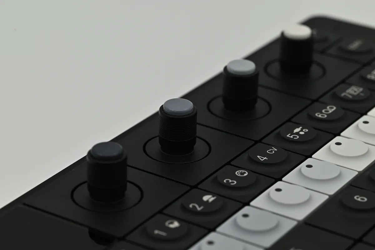 A close-up photo of the OP-XY's four encoder knobs.