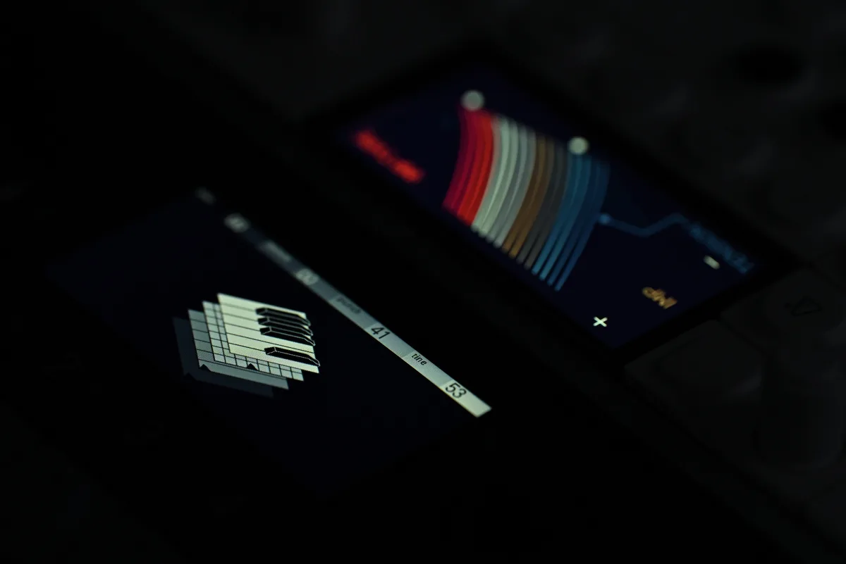 A close-up photo comparing the OP-XY's built-in LCD screen to that of the OP-1 field.