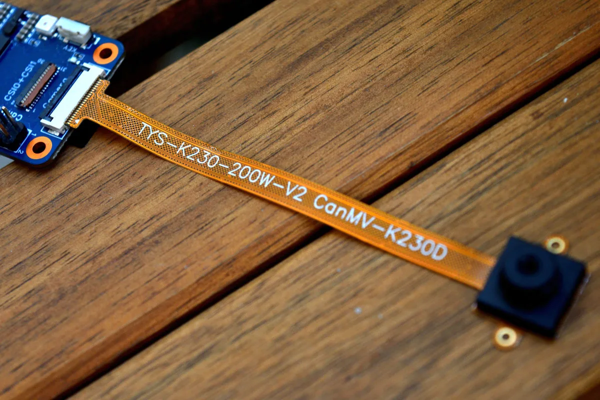 A close-up photo of the Banana Pi CanMV-K230D-Zero camera cable connecting the board with the camera module.