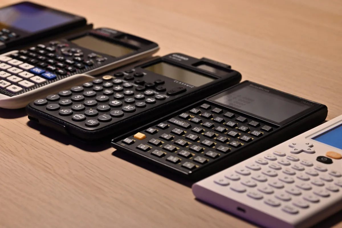 A photo taken during preparations for calculator benchmarking, showing the units used: an HP Prime, a Casio fx-991EX, a Casio fx-991CW, the DM42n and a Numworks N110.