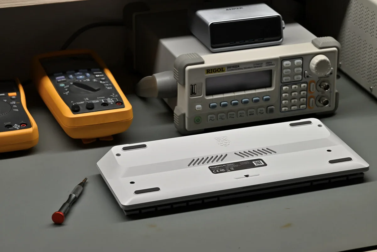 A photo of the Pi 500+ sitting upside down on a lab bench, reassembled after being taken apart.