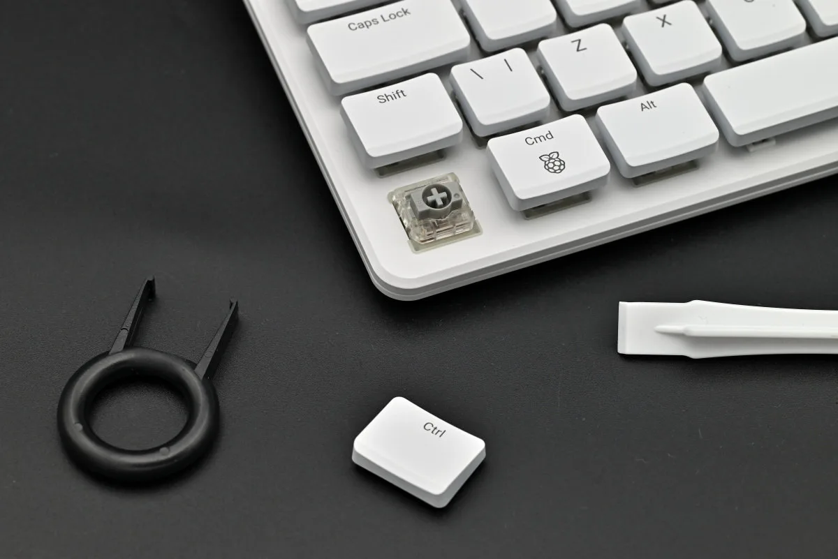 A photo showing the the control keycap removed from its switch, with the keycap puller and Uspudger in view.