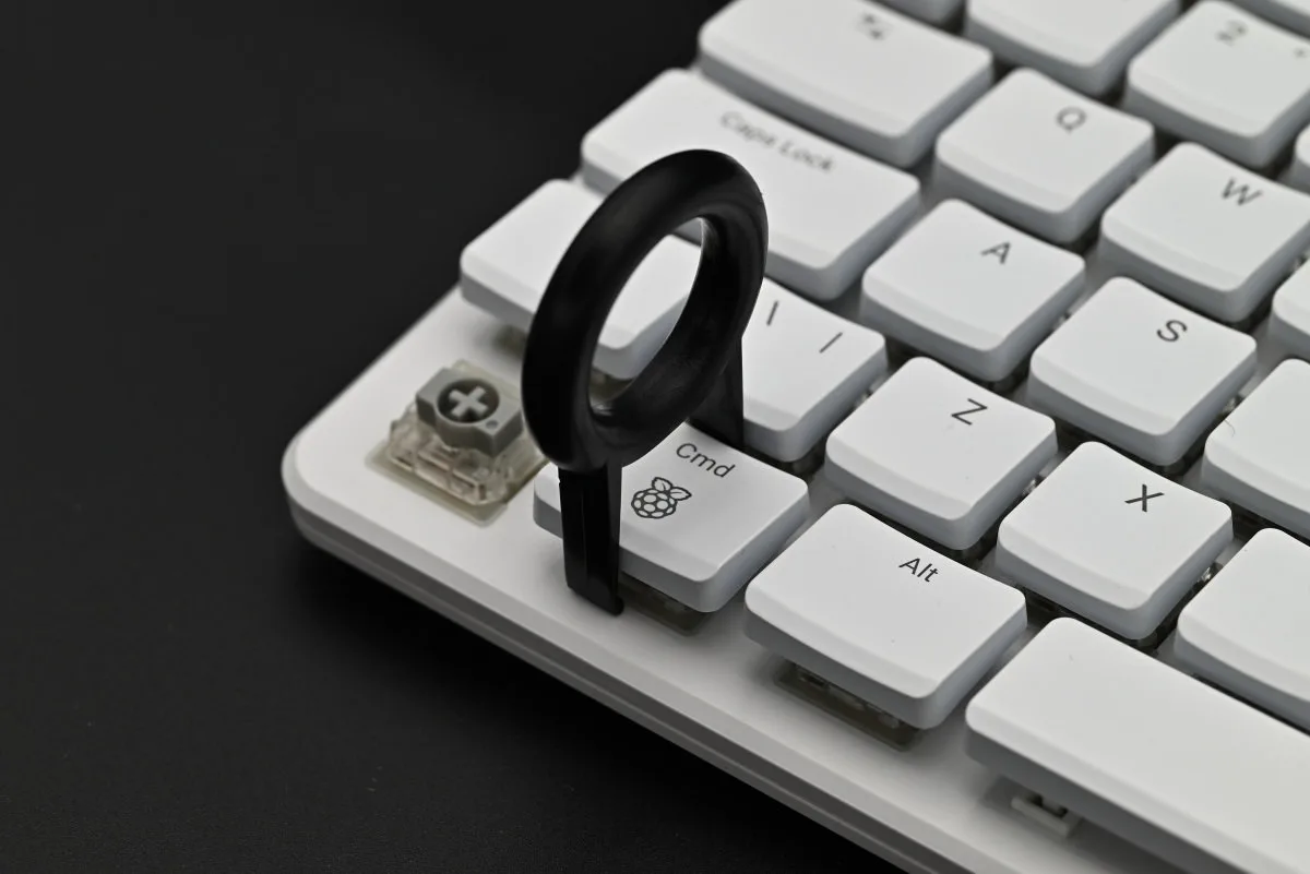 A photo showing the keycap puller used on the command key of the Raspberry Pi 500+.