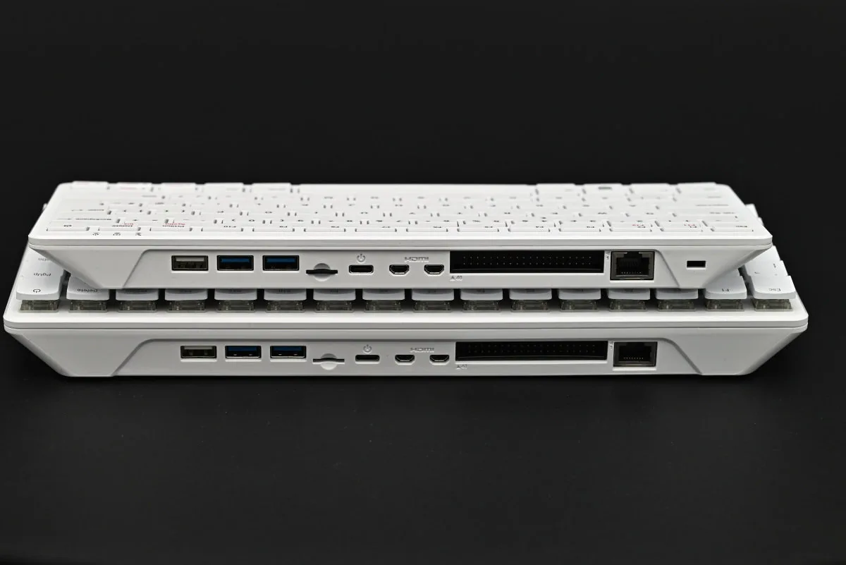 A photo showcasing the Raspberry Pi 500+ and Raspberry PI 500 sitting atop each other, showing that the port selection is identical.