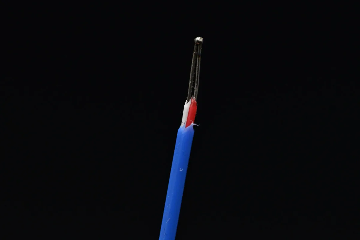 A close-up photo of the included thermocouple's bimetallic joint.