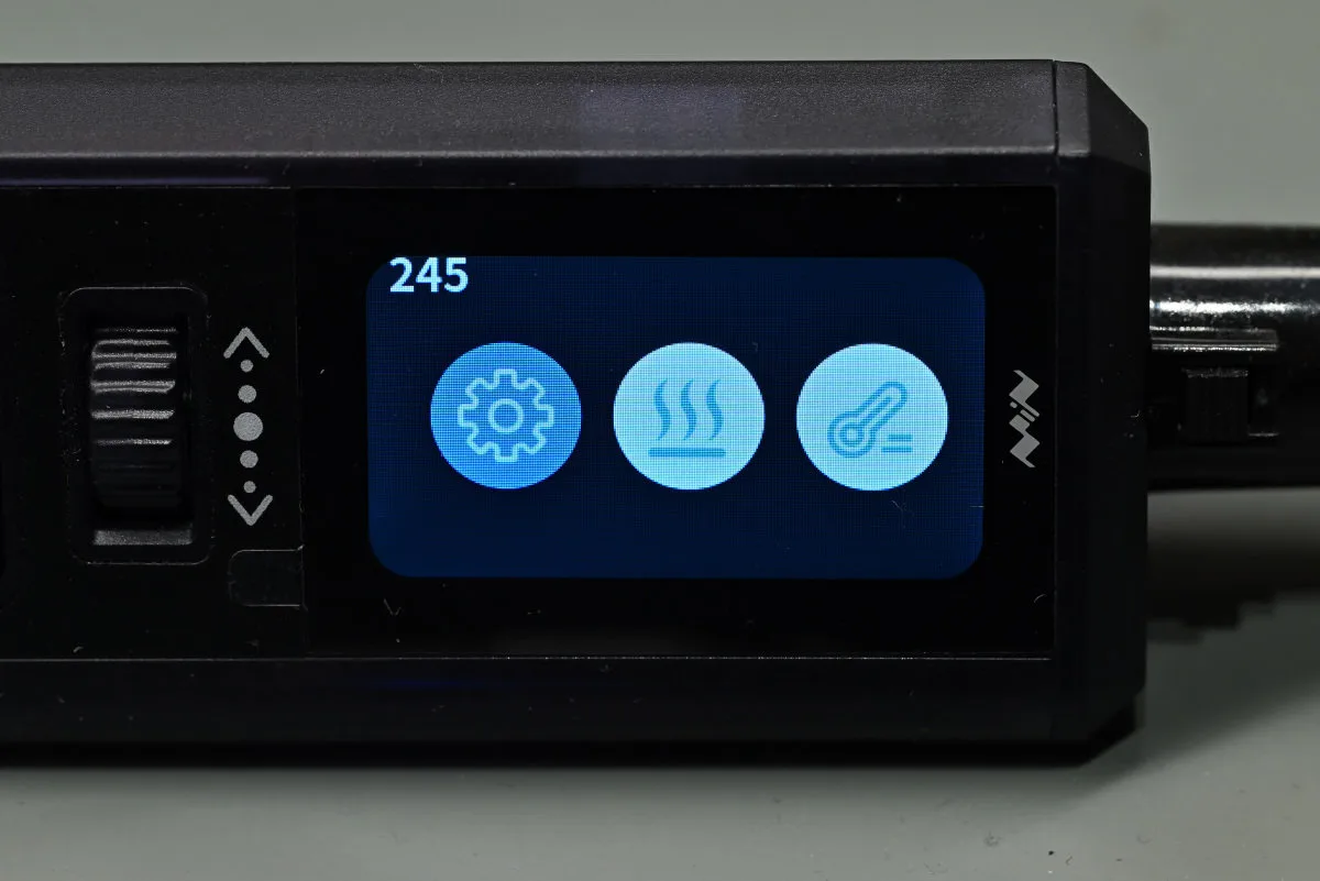 A photo of the TS1M's main screen, showing the main menu with three options (settings, heating mode, temperature measurement mode).