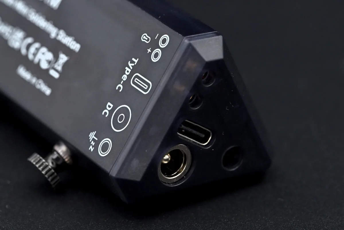 A close-up photo of the TS1M station's ports, together with the pictograms on the backside, displaying their purpose.