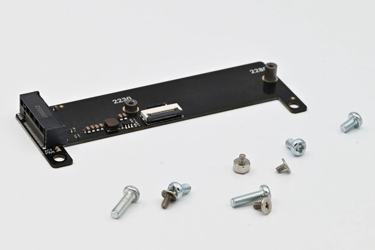A photo of the M.2 expansion board with the associated screws provided in the set.