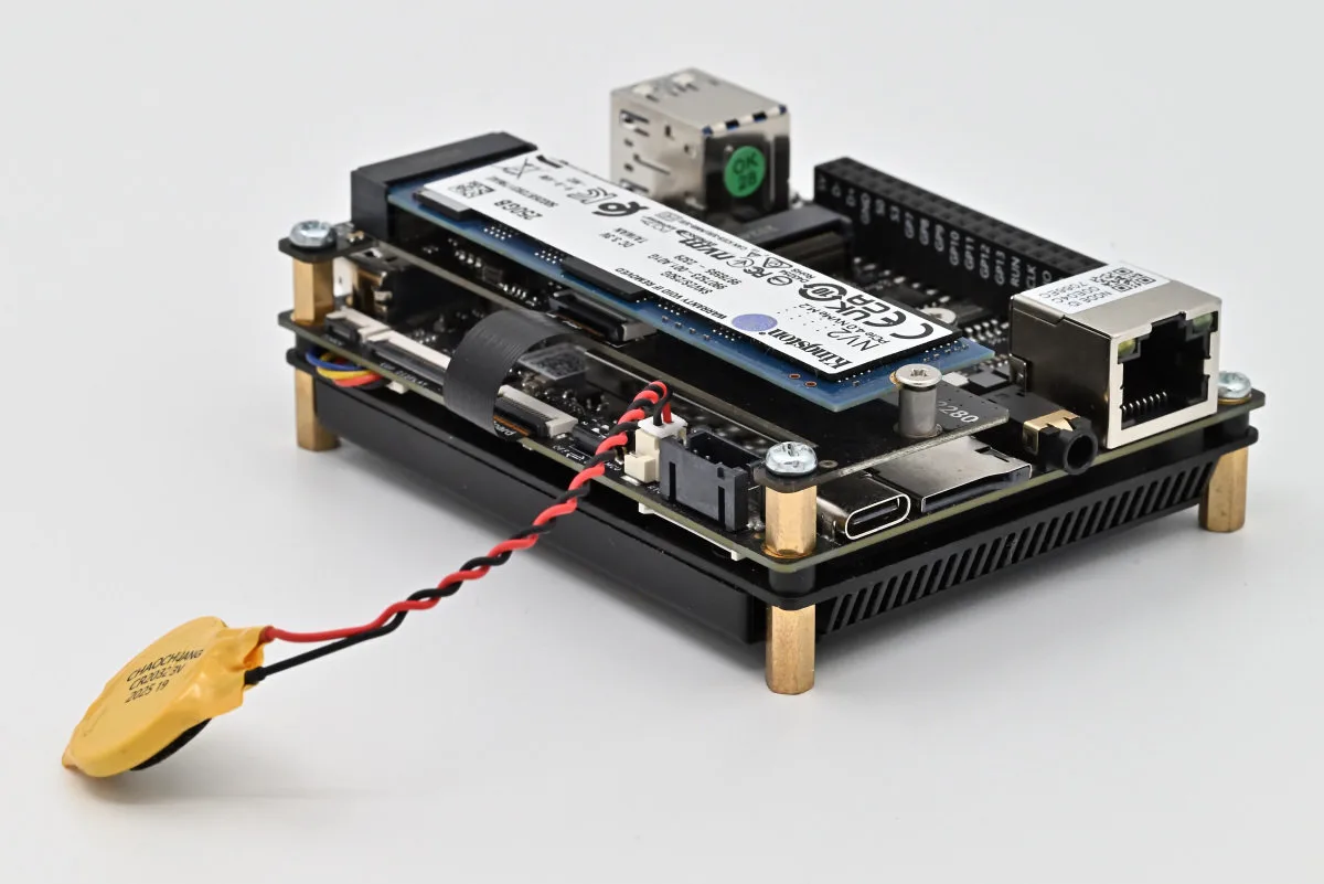 A photo of the IOTA, with its expansion board and third-party SSD, as well as its RTC battery prominently placed.