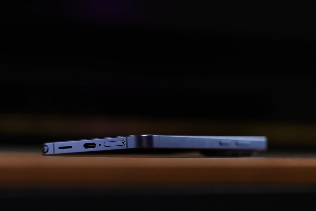 A low-angle shot of the phone, sitting on top of a desk, showing its tilt and elevation when standing on flat surfaces, caused by its camera protrusion.