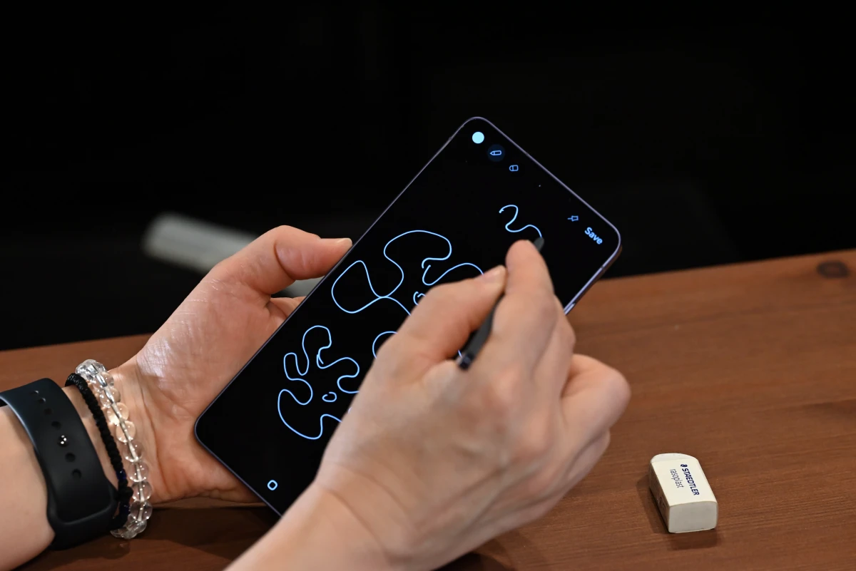 A photo of the S Pen being used to scribble on the phone's display.